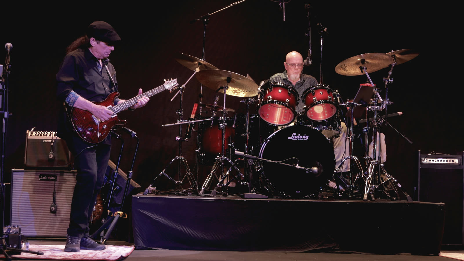 Allen on guitar in front of Ed's drum kit.