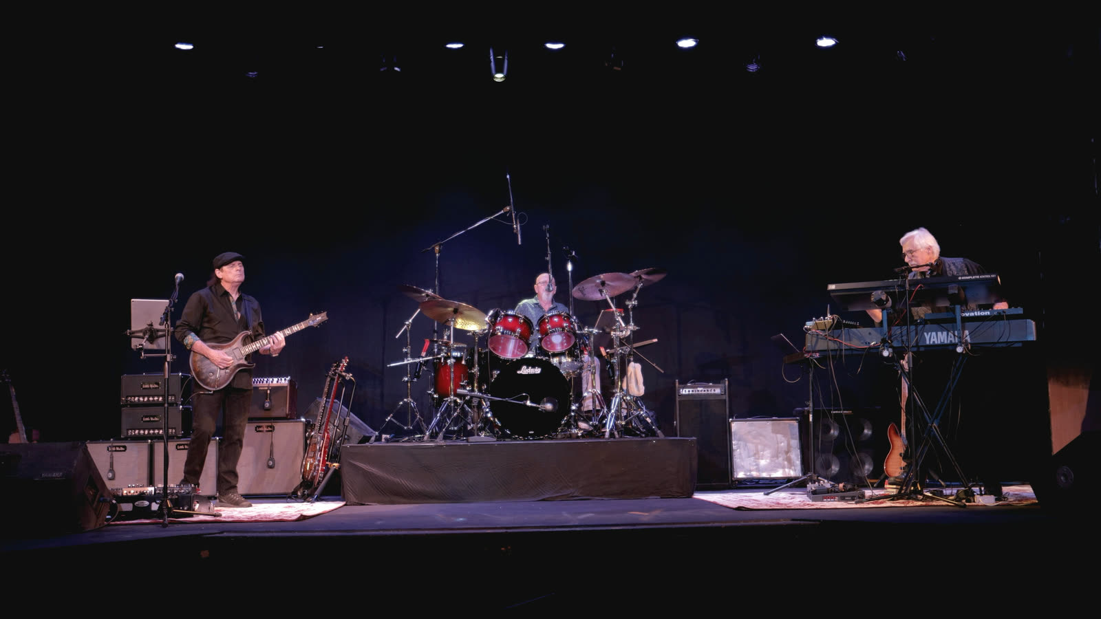The band on stage: Allen on guitar, Ed on drums, and Rico at the keyboards.